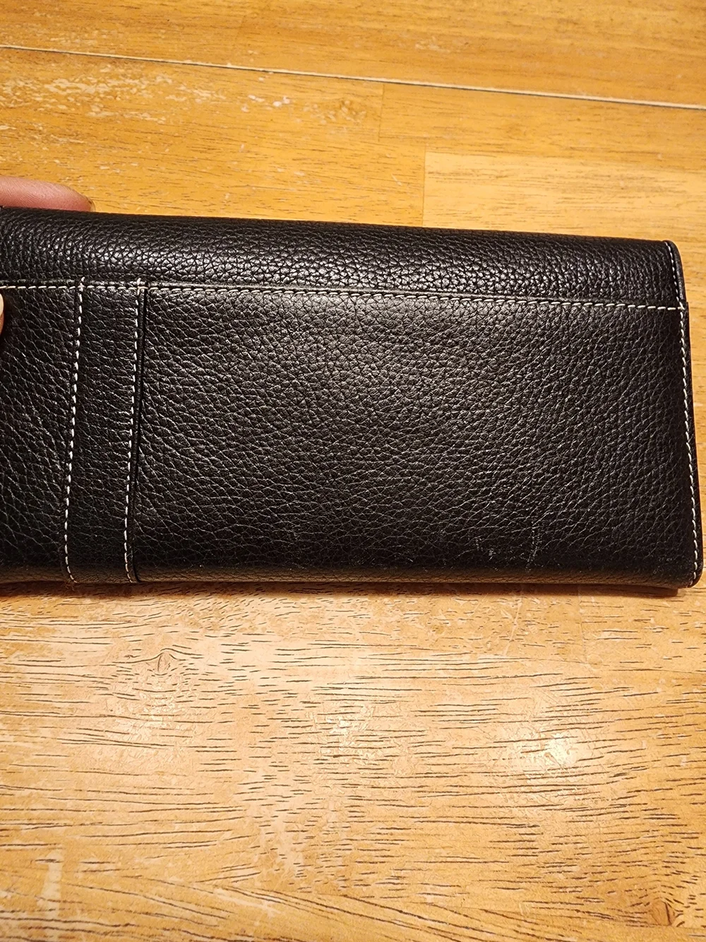 black Christian Dior pebbled leather trifold long wallet featuring gold-tone 